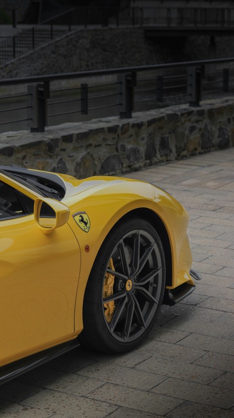 a yellow sports car parked on the side of the road