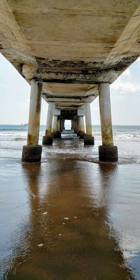 the underside of a bridge over a body of water