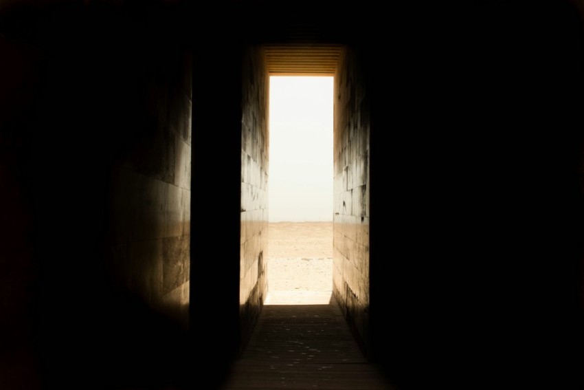 man standing between pillars