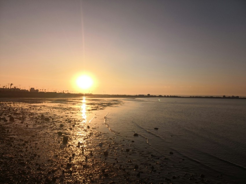 a body of water with a tower in the distance