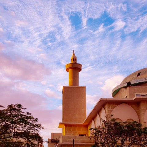 a tall building with a yellow dome on top of it