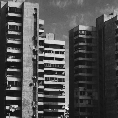 a black and white photo of tall buildings