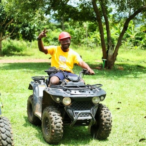 a man riding on the back of a four wheeler