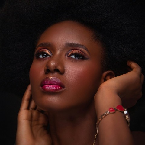 a woman with an afro is posing for a picture