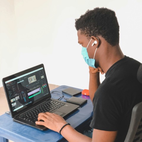 man in black crew neck t shirt using black laptop computer