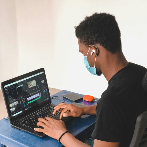 man in black crew neck t shirt using black laptop computer