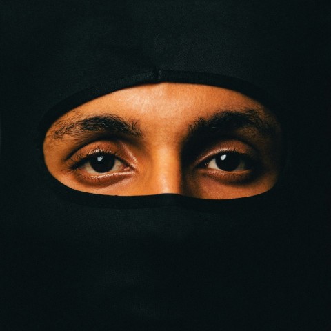 a close up of a person wearing a black head covering