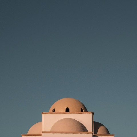 brown concrete building under blue sky during daytime