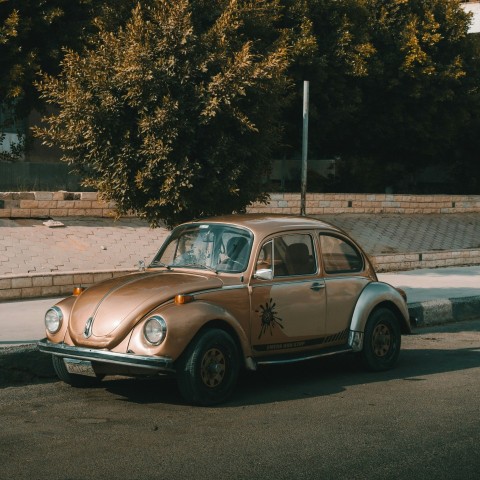 an old car parked on the side of the road zkl7gfeRh