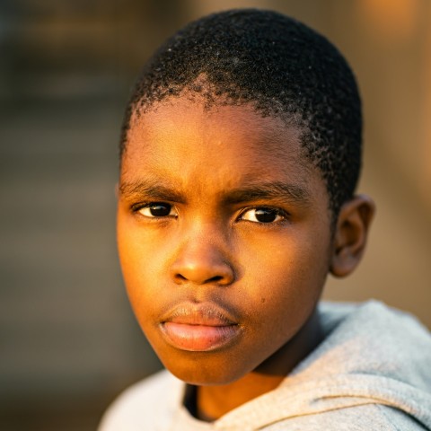 boy in white shirt looking up