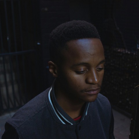 selective focus photography of man wearing gray button up jacket