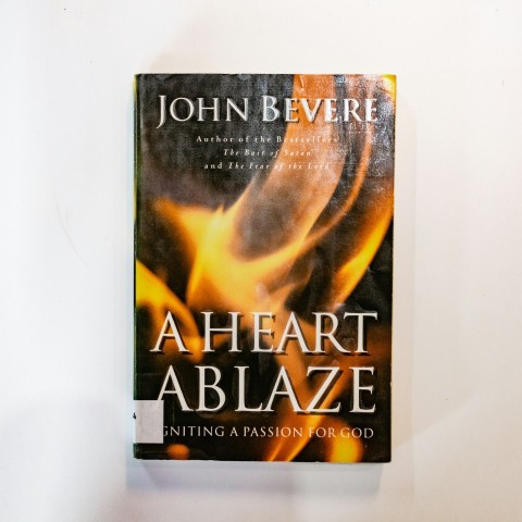 a book about a heart ablaze sitting on a table iwx5Pn6uZ