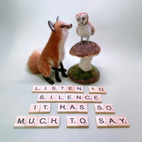 a fox and a bird sitting on top of a mushroom