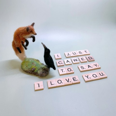 a fox and a bird are playing with scrabbles