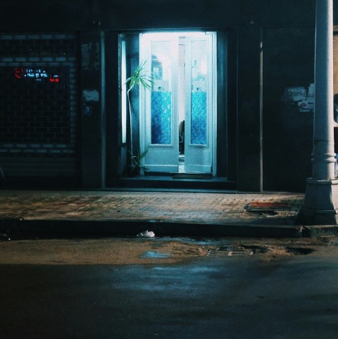 an open door to a building at night