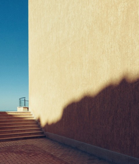 the shadow of a person standing on a set of stairs