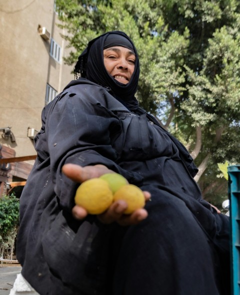 a person holding a couple of lemons