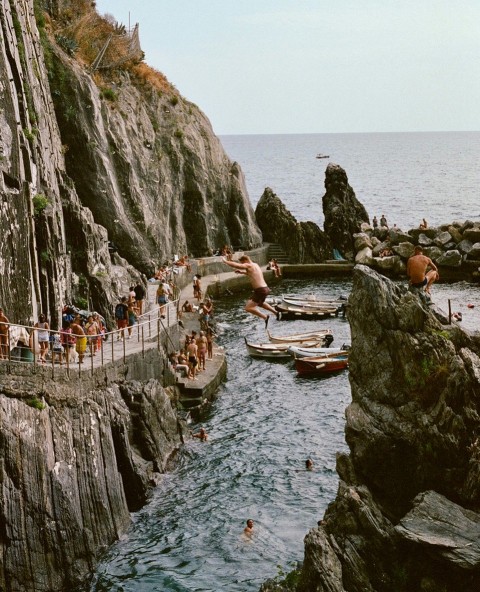 a group of people swimming in a body of water F