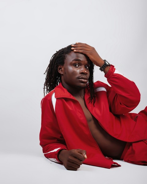 woman in red blazer covering her face with her hair