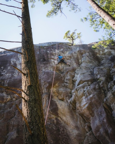 a man climbing up the side of a mountain