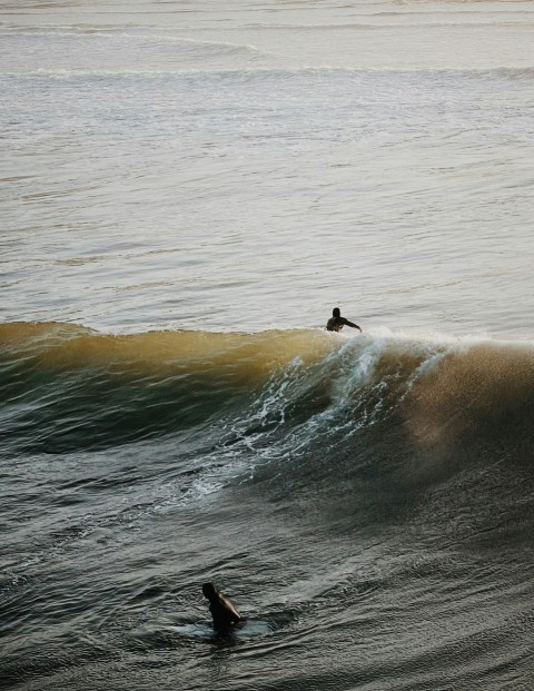 a person riding a wave on top of a surfboard