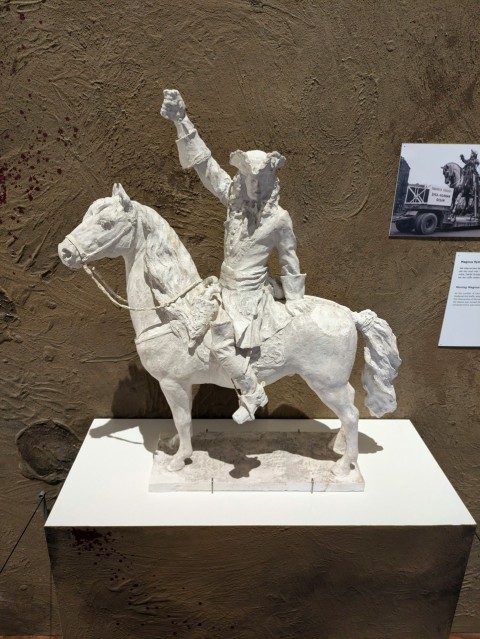 a statue of a man riding a white horse