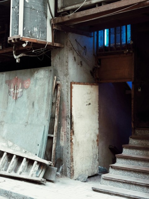 a run down building with a bunch of stairs