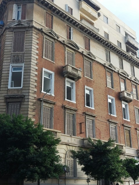 a tall brick building with lots of windows