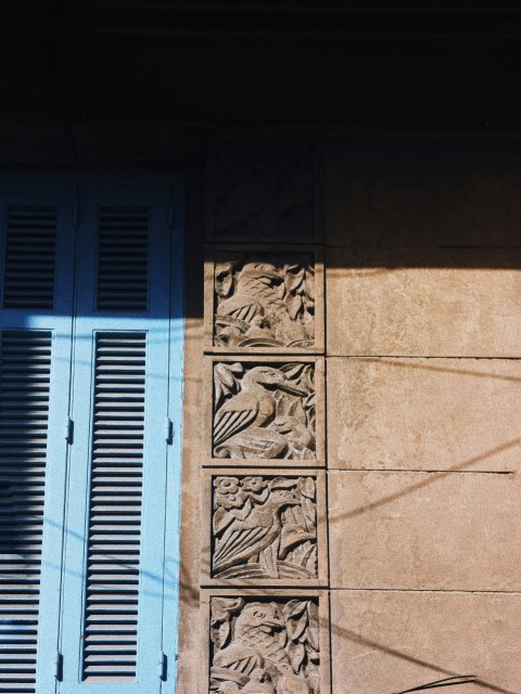 a building with a blue window and shutters