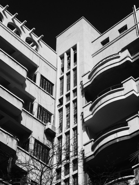 a black and white photo of a building with balconies