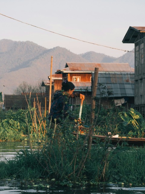 a man standing on a boat in a body of water