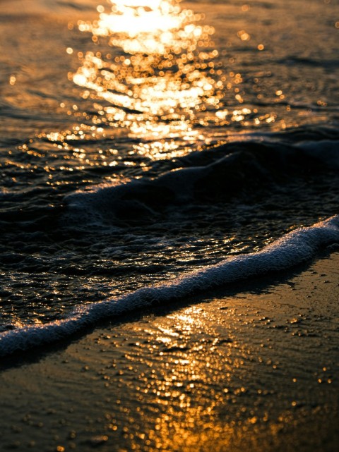 a close up of a wave on a beach