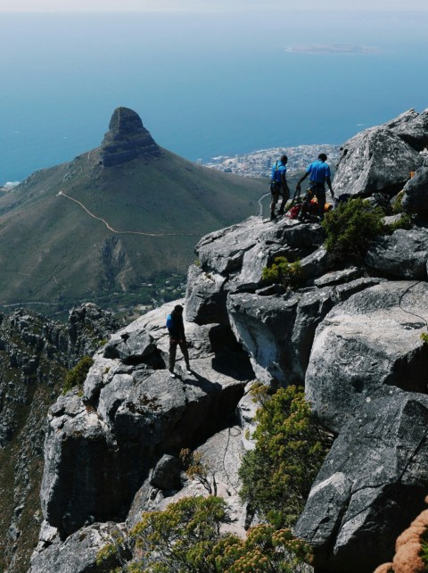 a group of people standing on top of a mountain