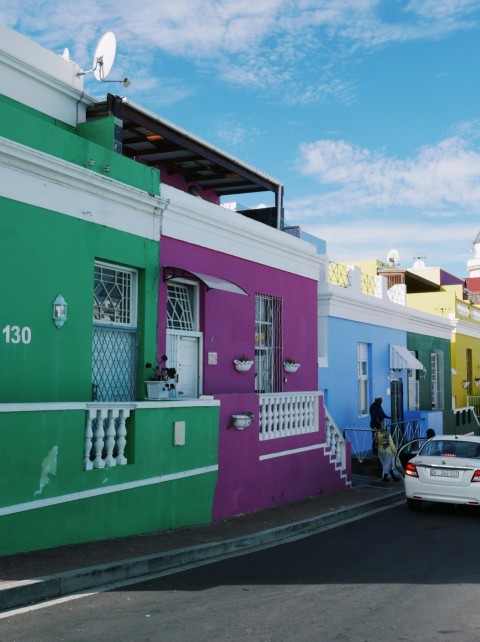 a car parked in front of a colorful building