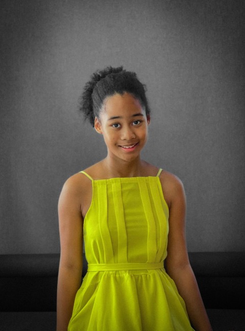 a woman in a yellow dress sitting down