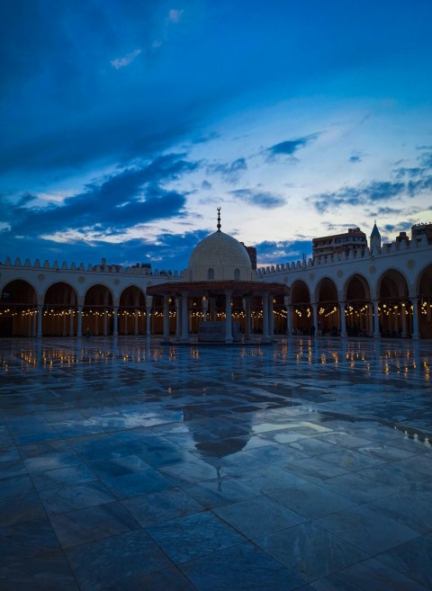 a large building with a dome and lights on it