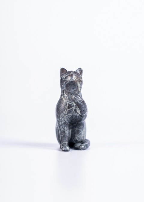 a small statue of a cat on a white background