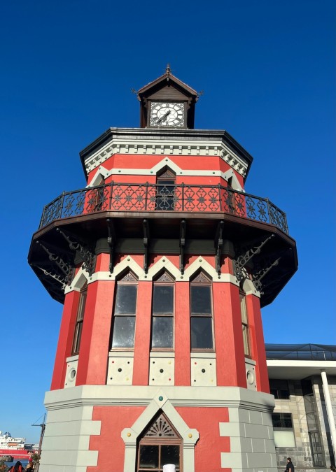 a red and grey building with a clock tower