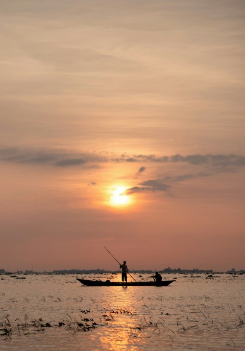 a man in a boat on a body of water