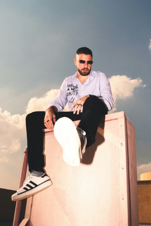 a man sitting on a large white object NIGuu2B