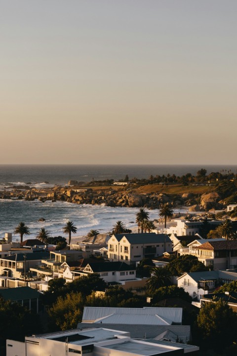 a view of the ocean and houses from a hill