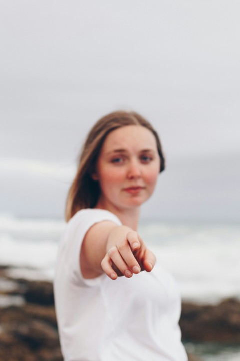 woman in white shirt pointing