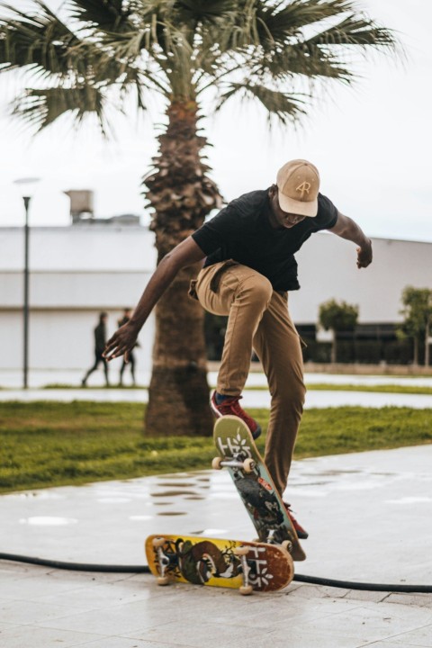 man wearing black crew neck t shirt skateboarding on pathway