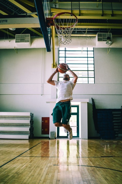 a person jumping to dunk a basketball