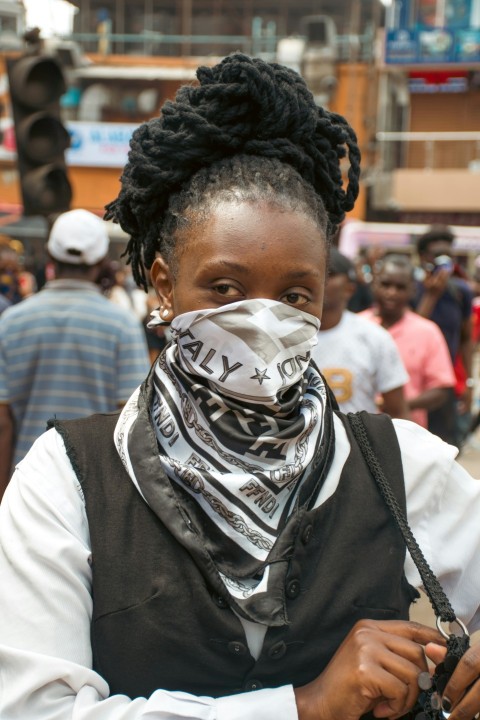 a woman with a bandana covering her face