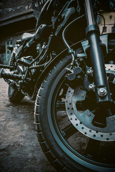 a close up of a motorcycle tire with a building in the background