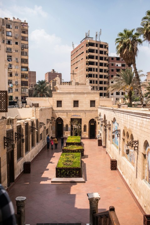 the courtyard of a building with a garden in the middle