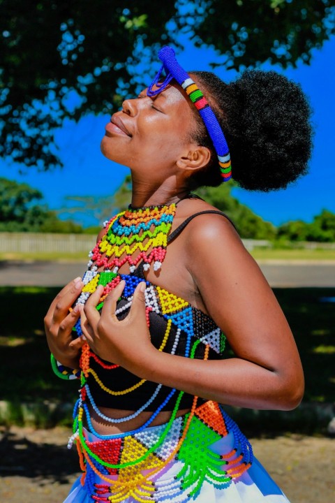 a woman wearing a colorful dress and a headband