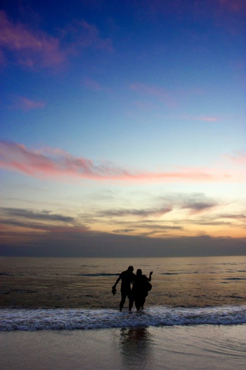 a couple of people that are standing in the water