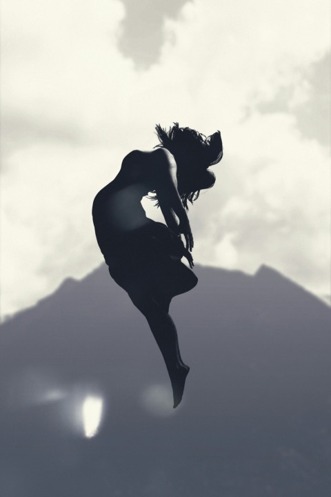 silhouette of person jumping in mid air during daytime